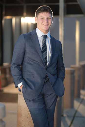 Noah Alter outdoors in a suit